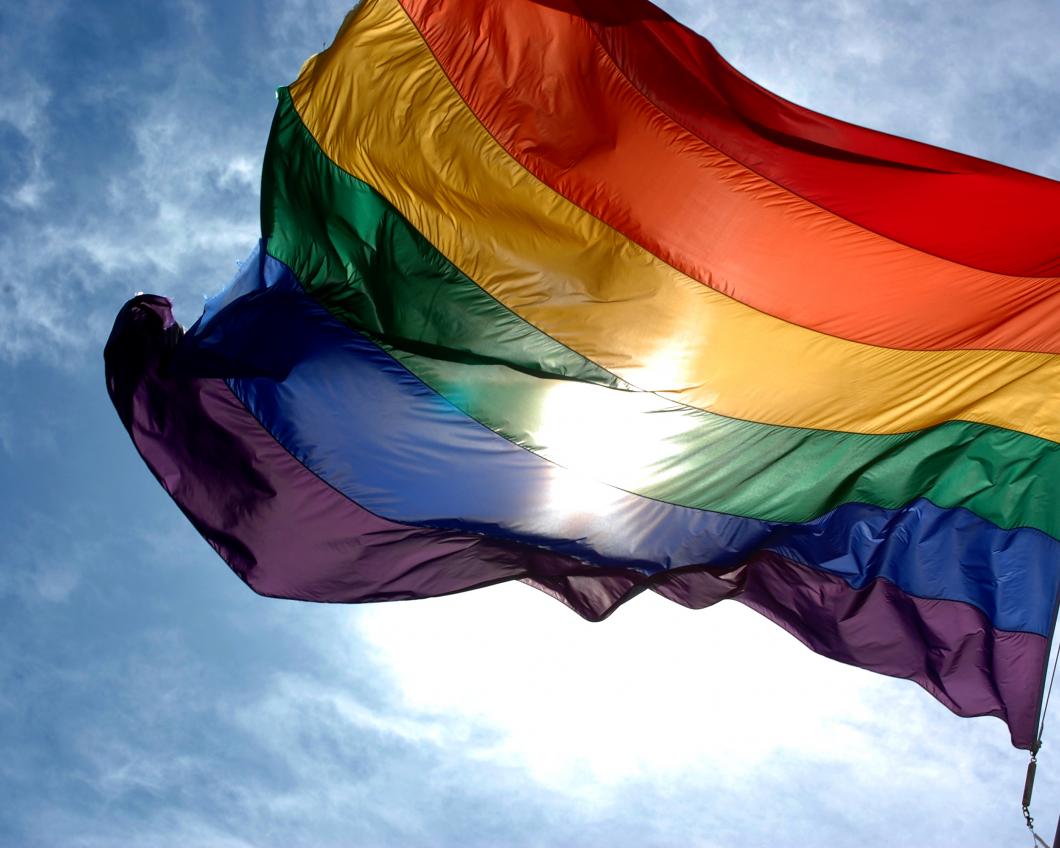 Rainbow_flag_and_blue_skies.jpg